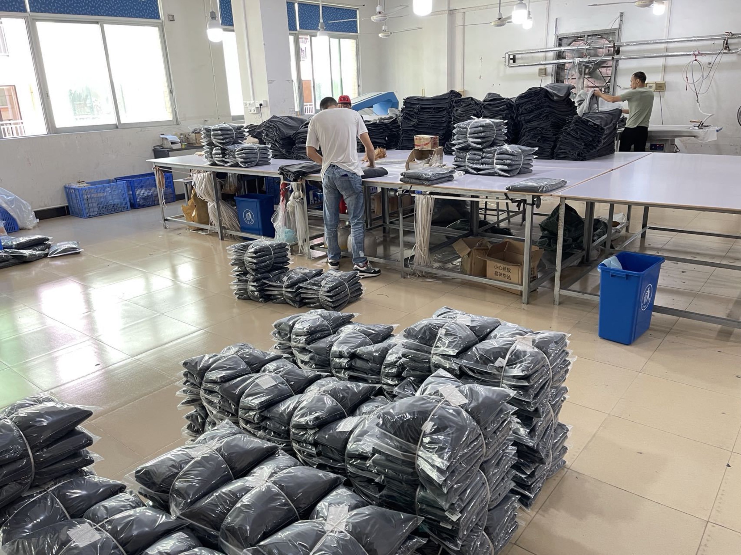 Finished garments being folded and prepared for packing