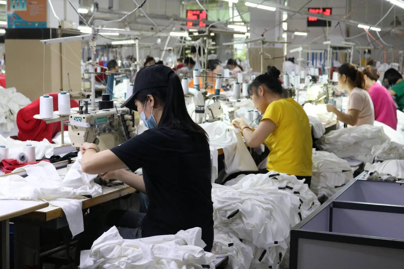 Sewing operators working along the garment production line