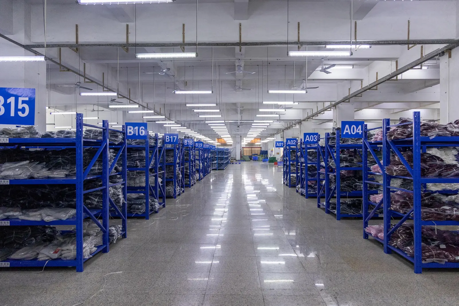 Packing cartons and fabric rolls stored on warehouse shelving