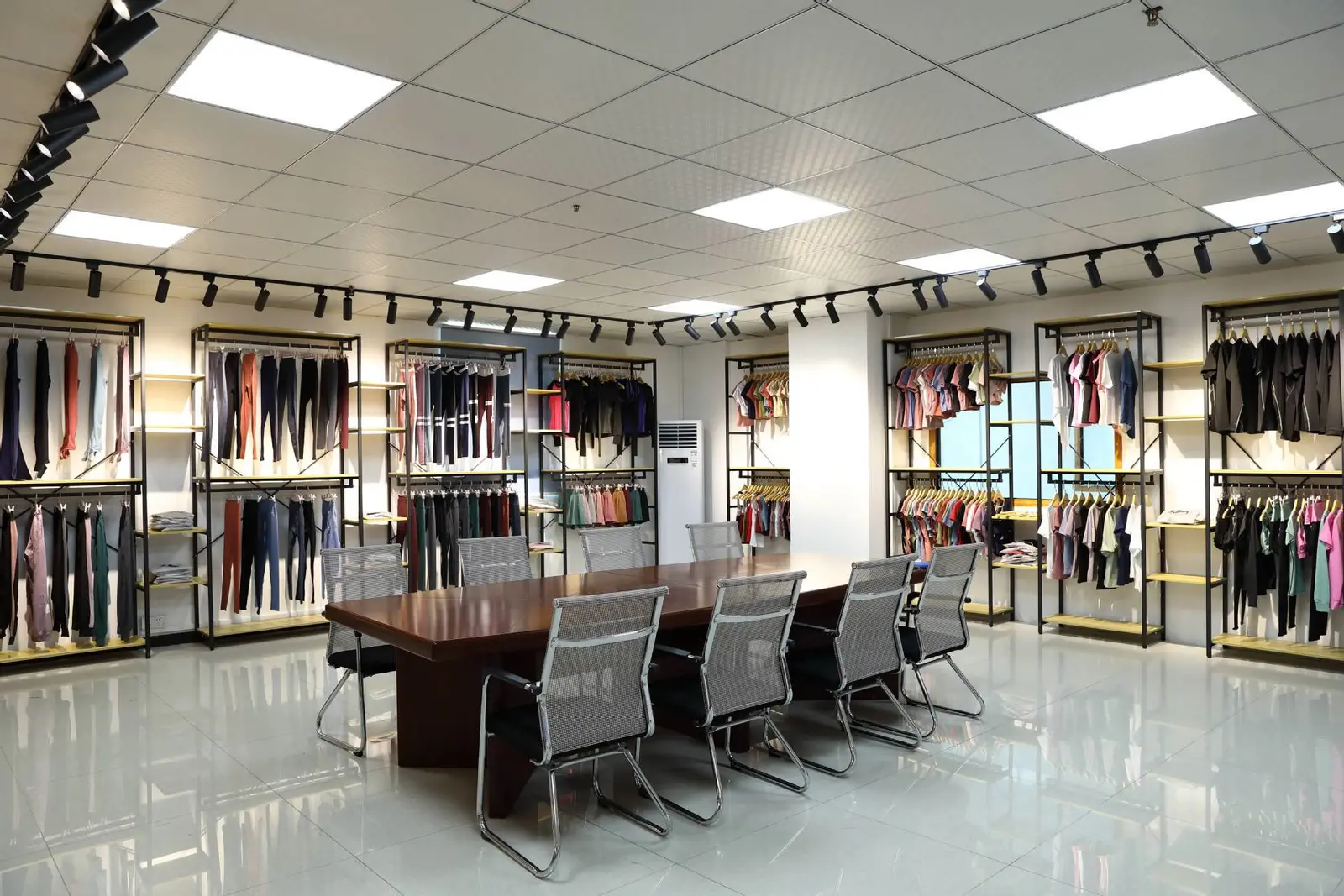 Finished T-shirts in multiple colors displayed on rails in the sample showroom